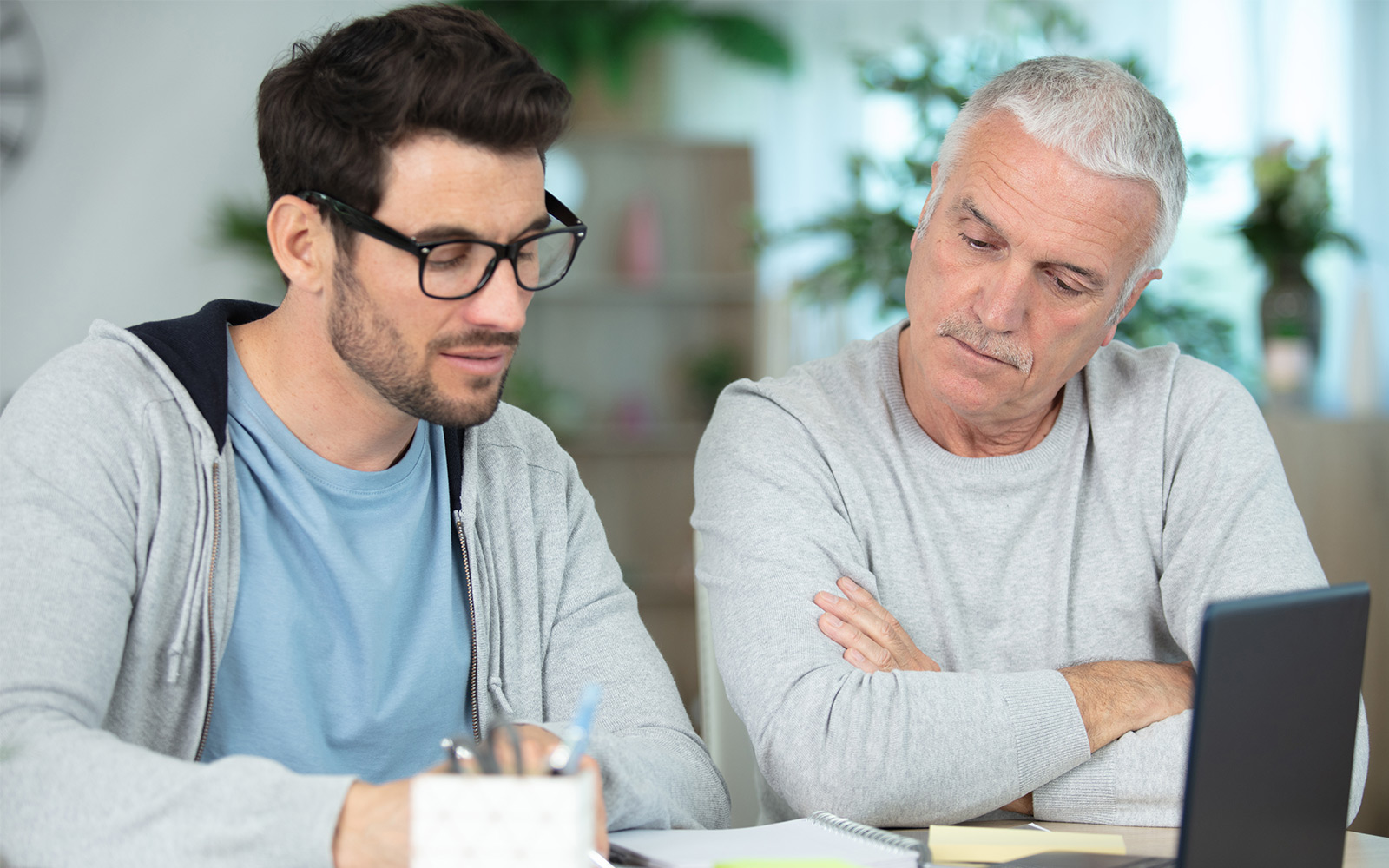 adult father and son discuss accounting and financial scenarios