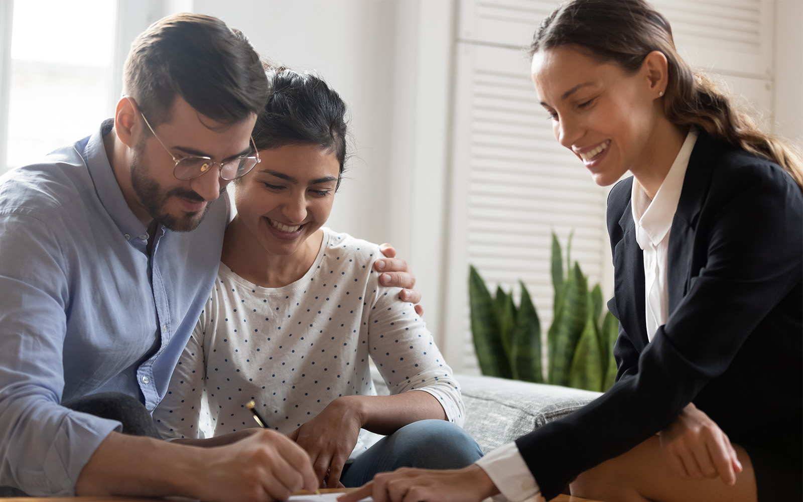 Couple working with professional and signing papers