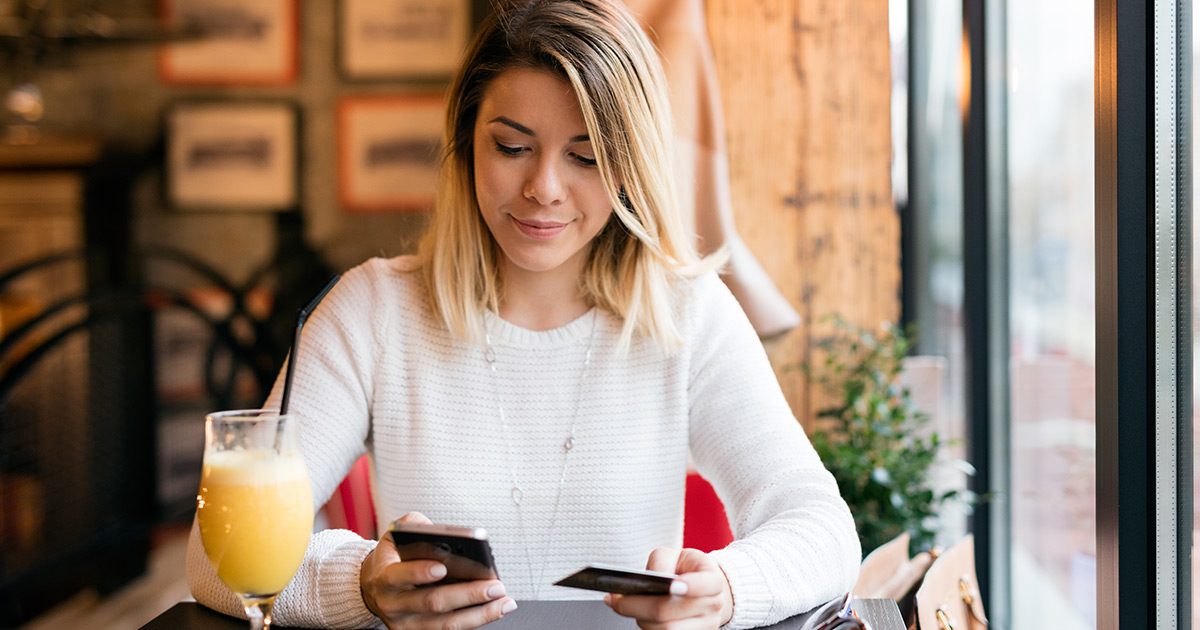 Consumer holding credit card and banking with mobile phone