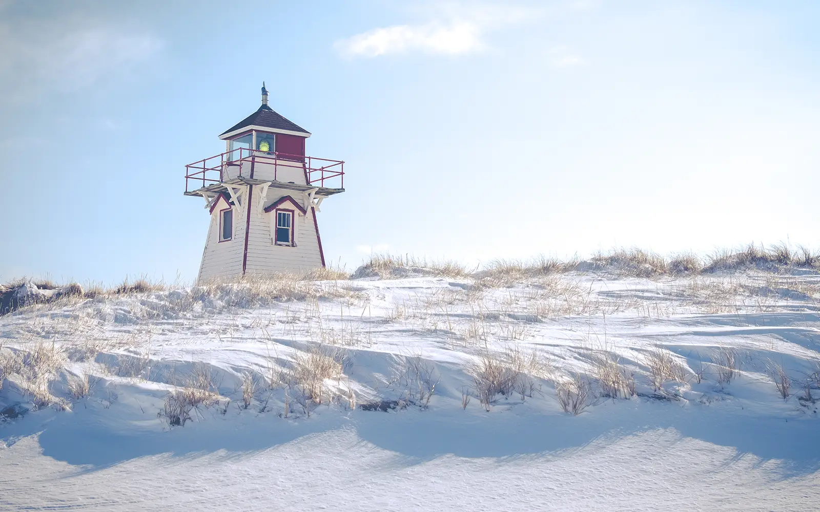 Lighthouse sitting on a snowy landscape
