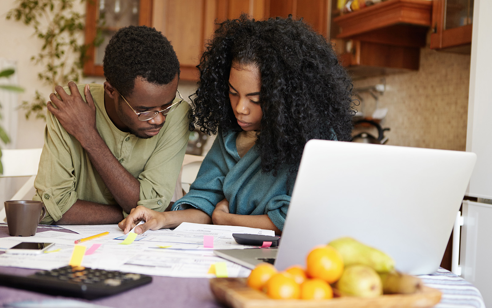 A couple sitting at a table reviewing paperwork