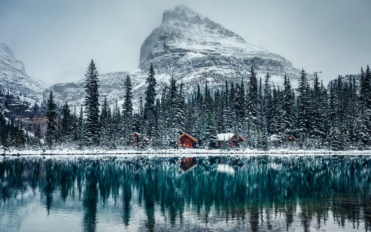 lake at winter with mountain face in back