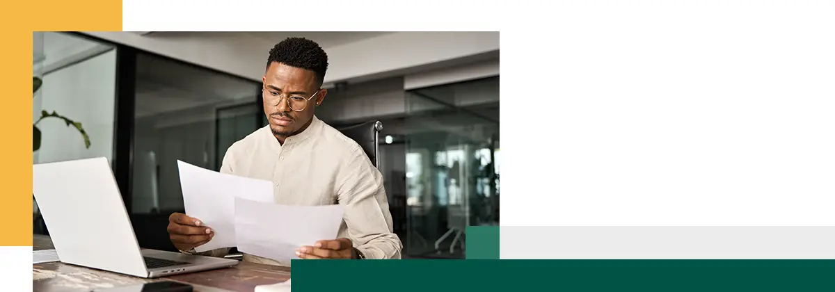 Serious businessman reading legal paper company file