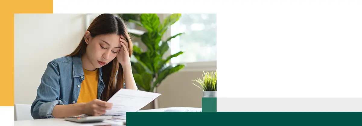 Young woman looking at credit card invoice