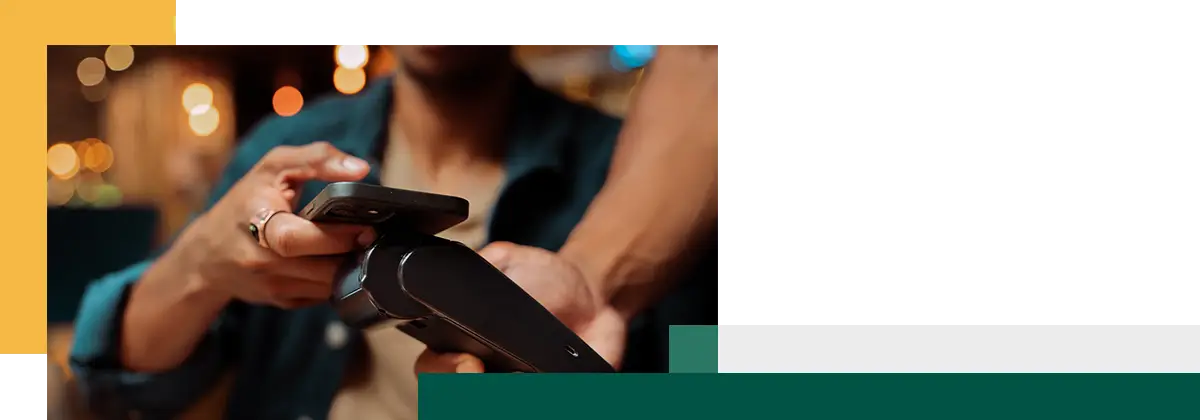 close up of customer paying with cellular device and card machine