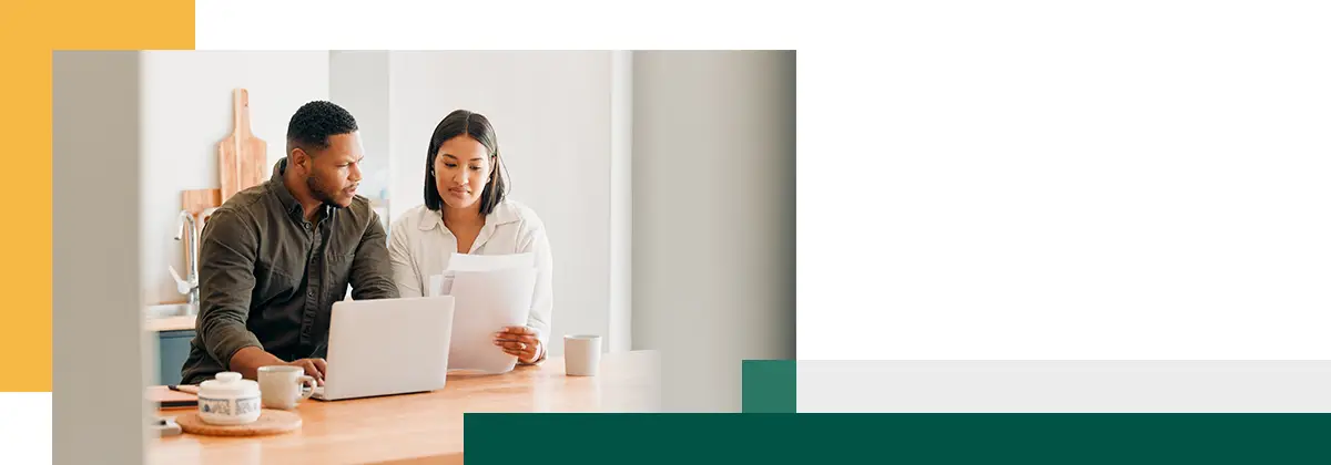 couple with laptop looking at budget bills or finance paper work