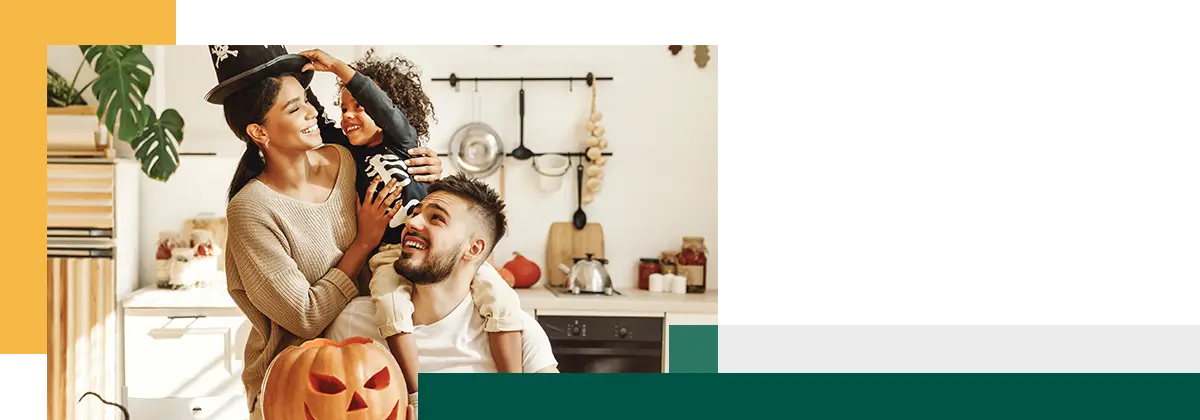 happy family mother father and little son have fun and celebrate Halloween at home