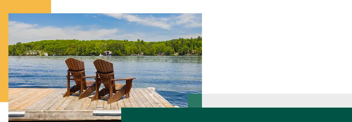 Two Adirondack chairs on a wooden dock