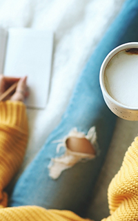 Sitting down with a coffee and notepad setting financial goals