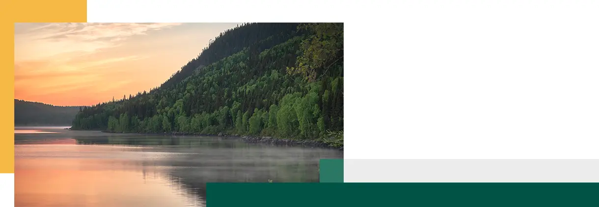 Beautiful Morning Sunrise on a Steamy Lake Surrounded by Mountains With Trees in Quebec Canada