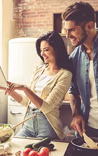 Young couple is making dinner at home
