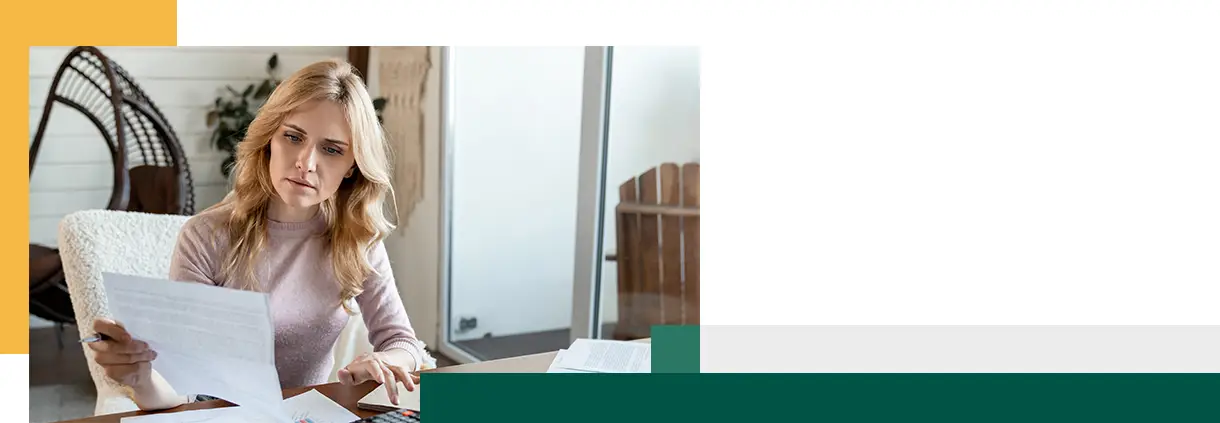 Focused woman looking through paper documents