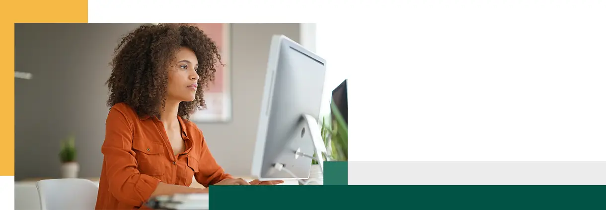 Cheerful businesswoman working on desktop