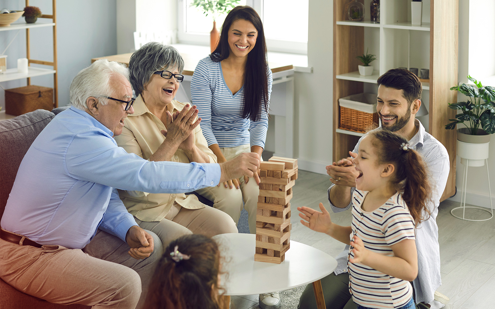 Family with children playing board games and having a good time together