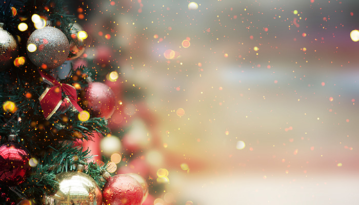 Decorated Christmas tree surrounded by glitter