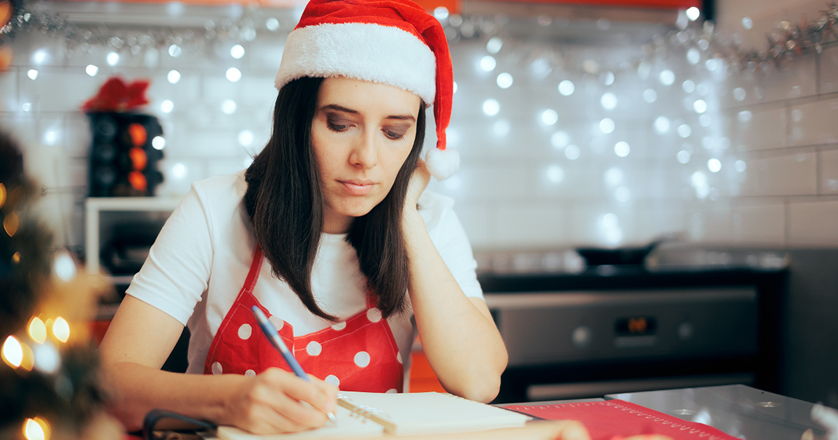woman making a list at Christmas time