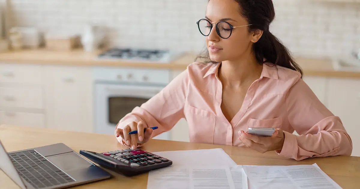 Woman working on financial tasks at home