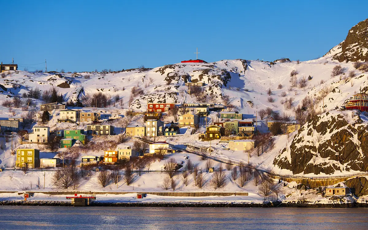 Houses along a waterfront on hillside snowcovered