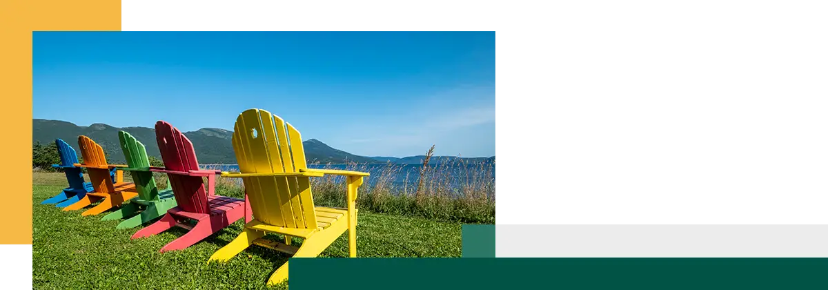 Colorful Adirondack Chairs Facing Bonne Bay on a Sunny Day in Newfoundland