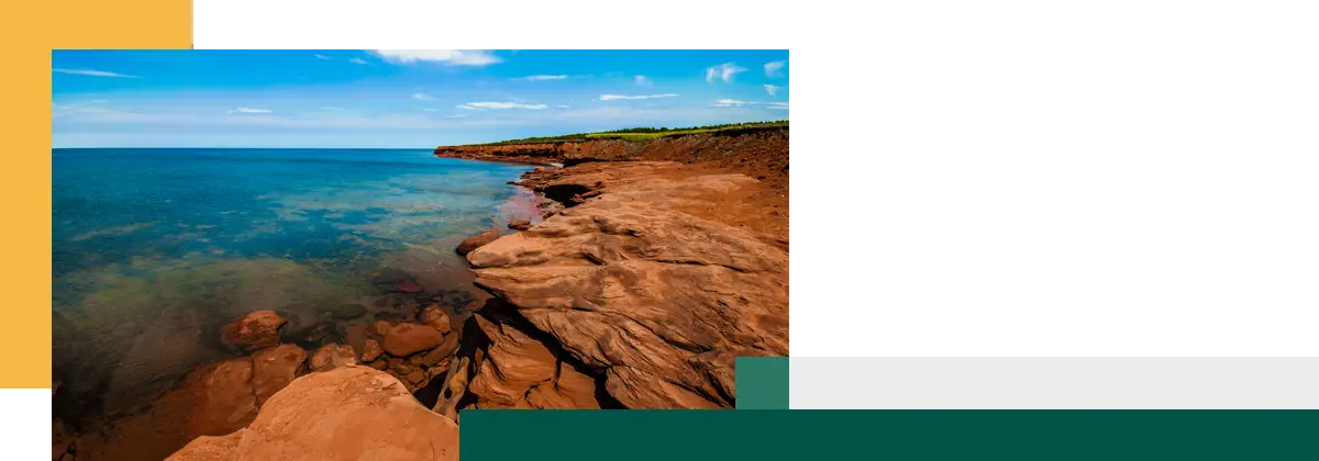 Rock cliff beach and clear water on a sunny day at Cavendish Prince Edward Island