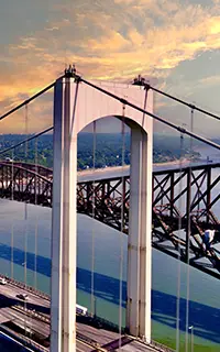 view of Quebec Bridge and Pierre Laporte Bridge over St Lawrence River at sunset