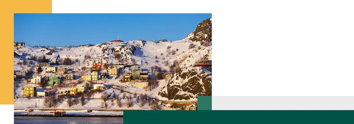 Photo of town in the winter with mountains in the background