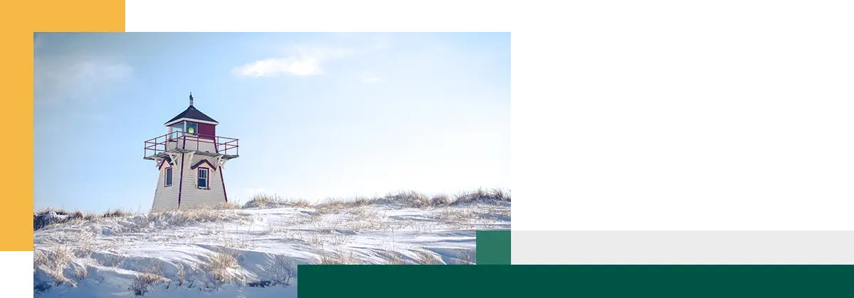 Snow covered field with a light house