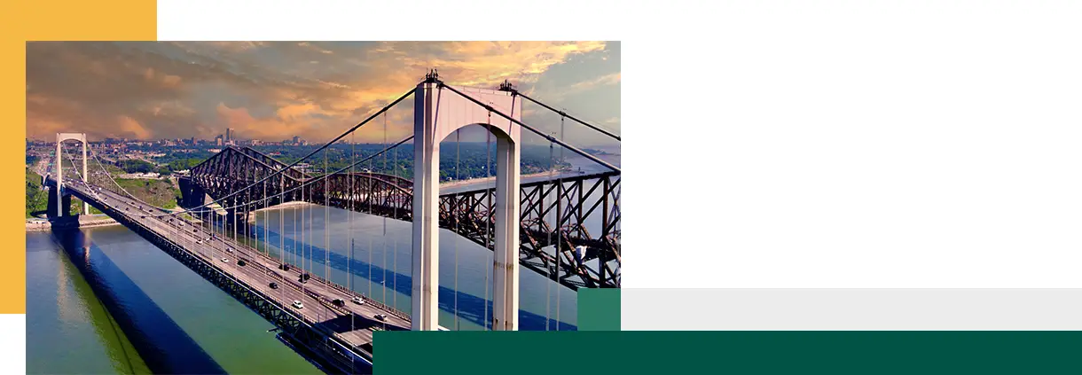 view of Quebec Bridge and Pierre Laporte Bridge over St Lawrence River at sunset