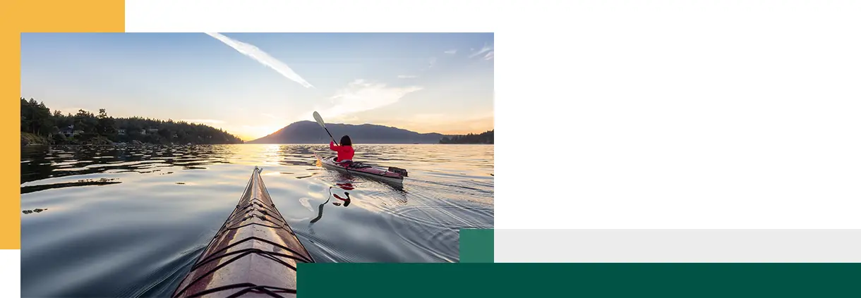 Woman on Sea Kayak paddling in the Pacific Ocean
