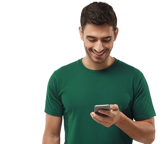 Man in green shirt looking down at his phone