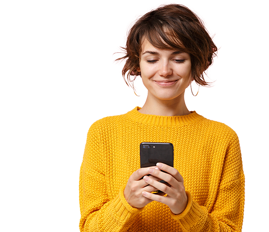 Woman smiling while messaging on her phone