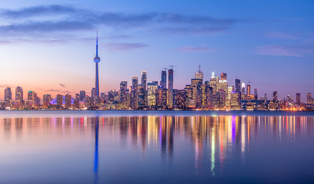 Toronto skyline at sunset with reflection of skyscrapers in the water