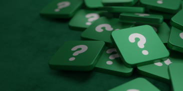 A pattern of green question marks set against a solid green background, symbolizing inquiry and curiosity.