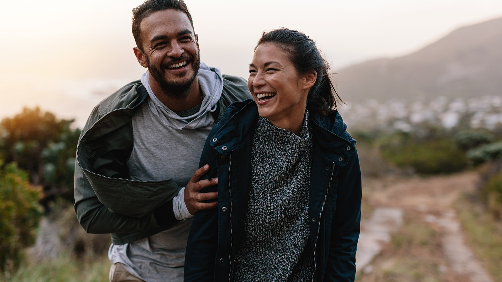 couple walking through a mountain pass