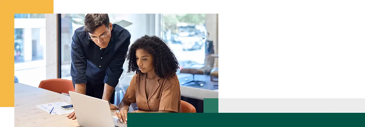 Business team of two diverse young professional executives working together