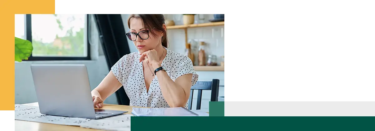 Focused woman making decisions while using a computer