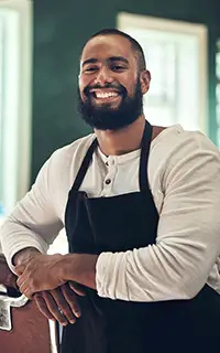 Barber shop owner, hair stylist and man portrait of an entrepreneur with smile