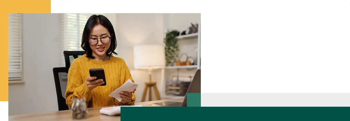 Asian woman calculating expenses and bill payments with a smartphone