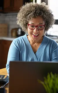 A mature woman budgeting at home in the kitchen