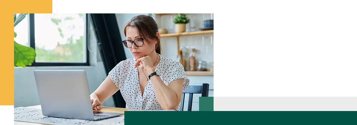 Man looking at laptop and thinking