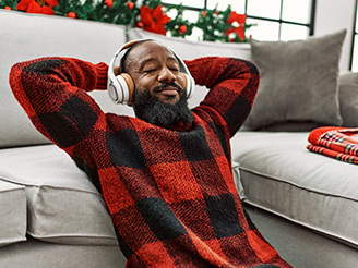 Man wearing pajama's relaxing listening to headphones