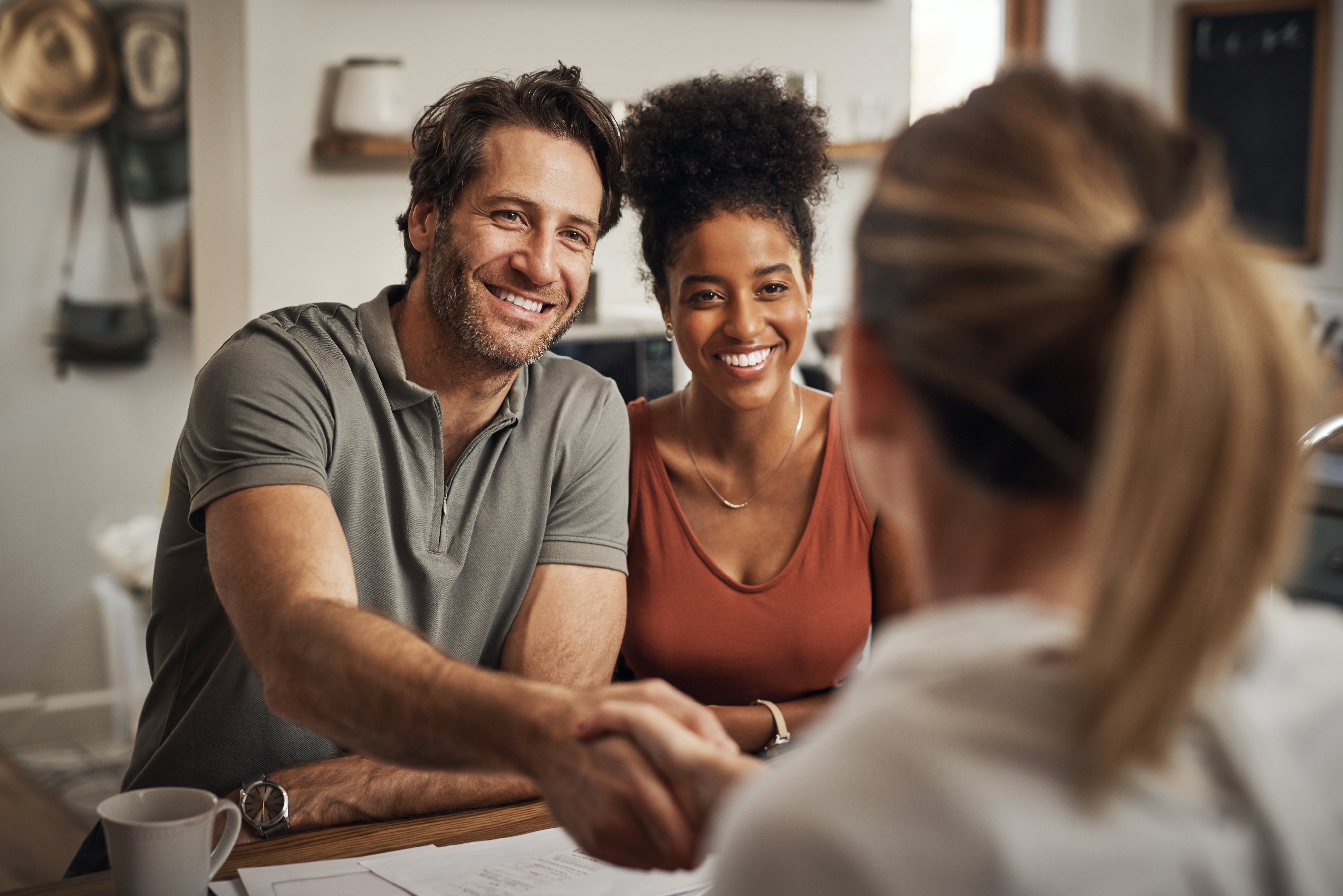 Couple shaking hands with a Licensed Insolvency Trustee.