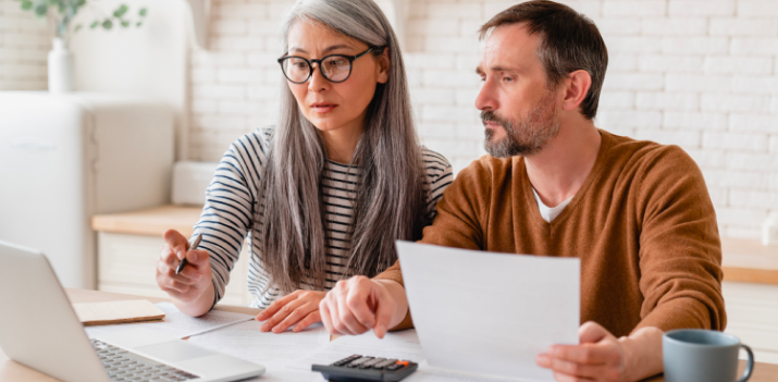 Individuals of different ages and backgrounds reviewing bankruptcy protection plans together.