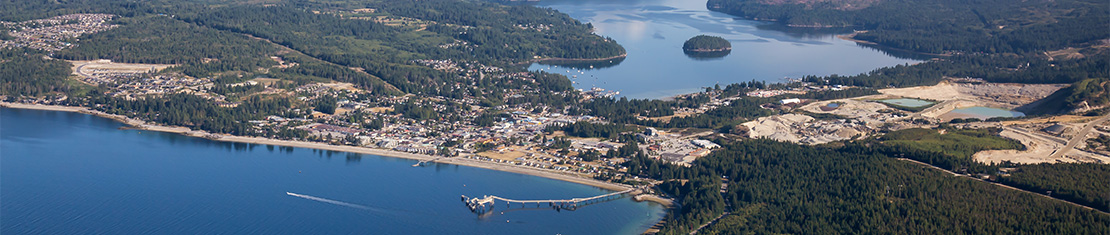 Aerial view of Sechelt surrounded by water.