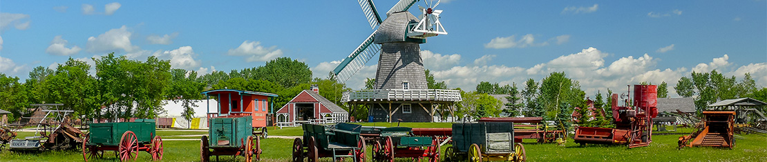 Dutch-style windmill surrounded by red buildings.