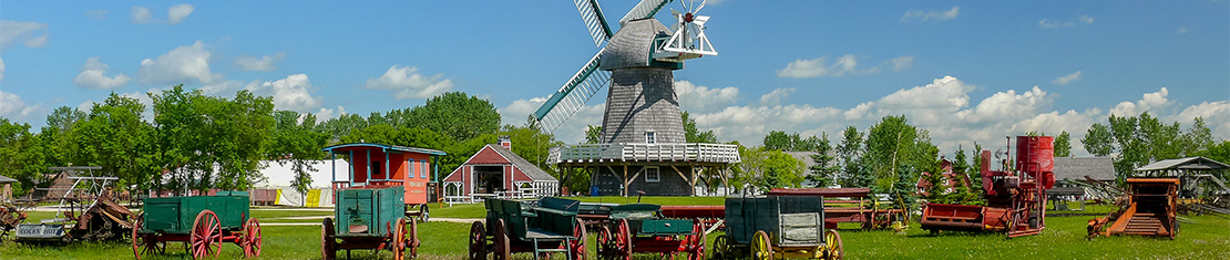 Dutch-style windmill surrounded by red buildings.