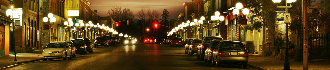 Street at night lit up by street lights.
