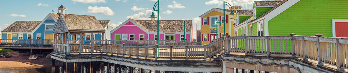 Bright blue, pink, green, and yellow houses on the coast.