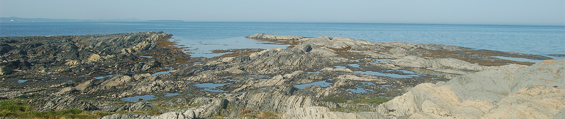 Rock mountains on the coast of a large body of water