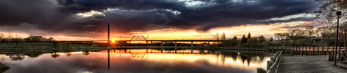 Decorative bridge over a body of water at sunset